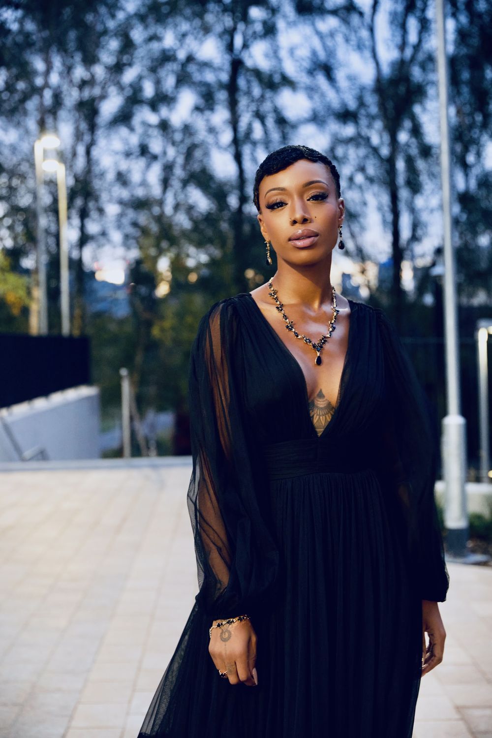 Paige Lewin in a black evening dress outdoors at dusk