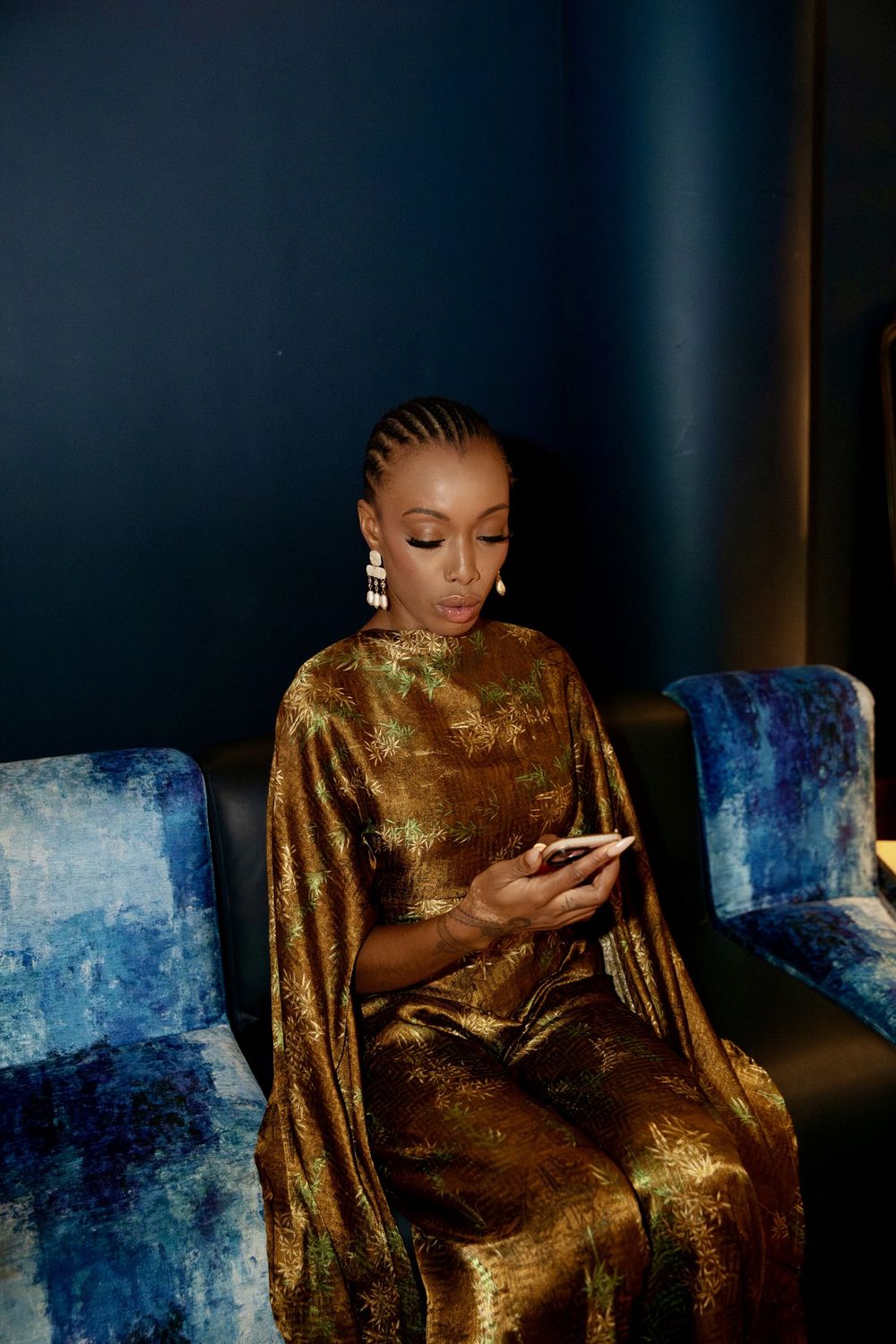Paige Lewin in a gold gown backstage