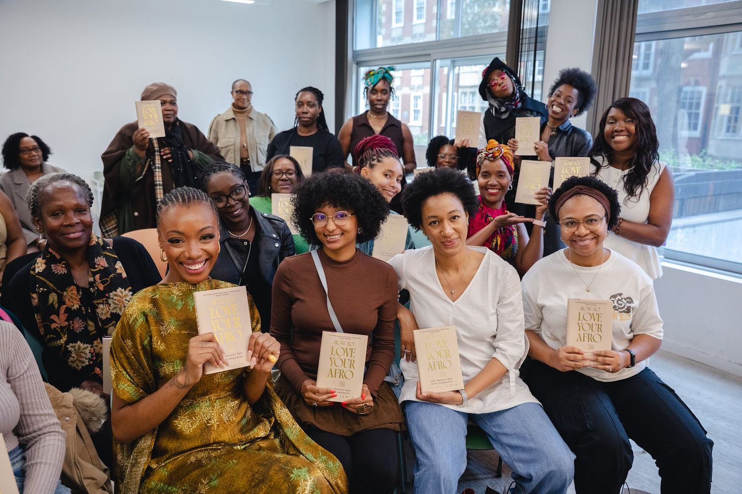 Readers holding copies of How to Love Your Afro with Paige