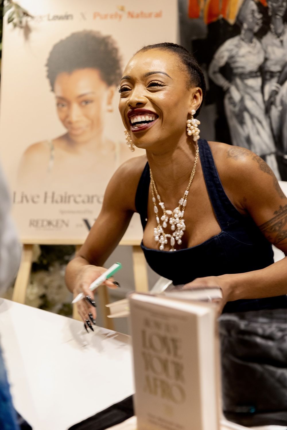 Paige signing copies of her book